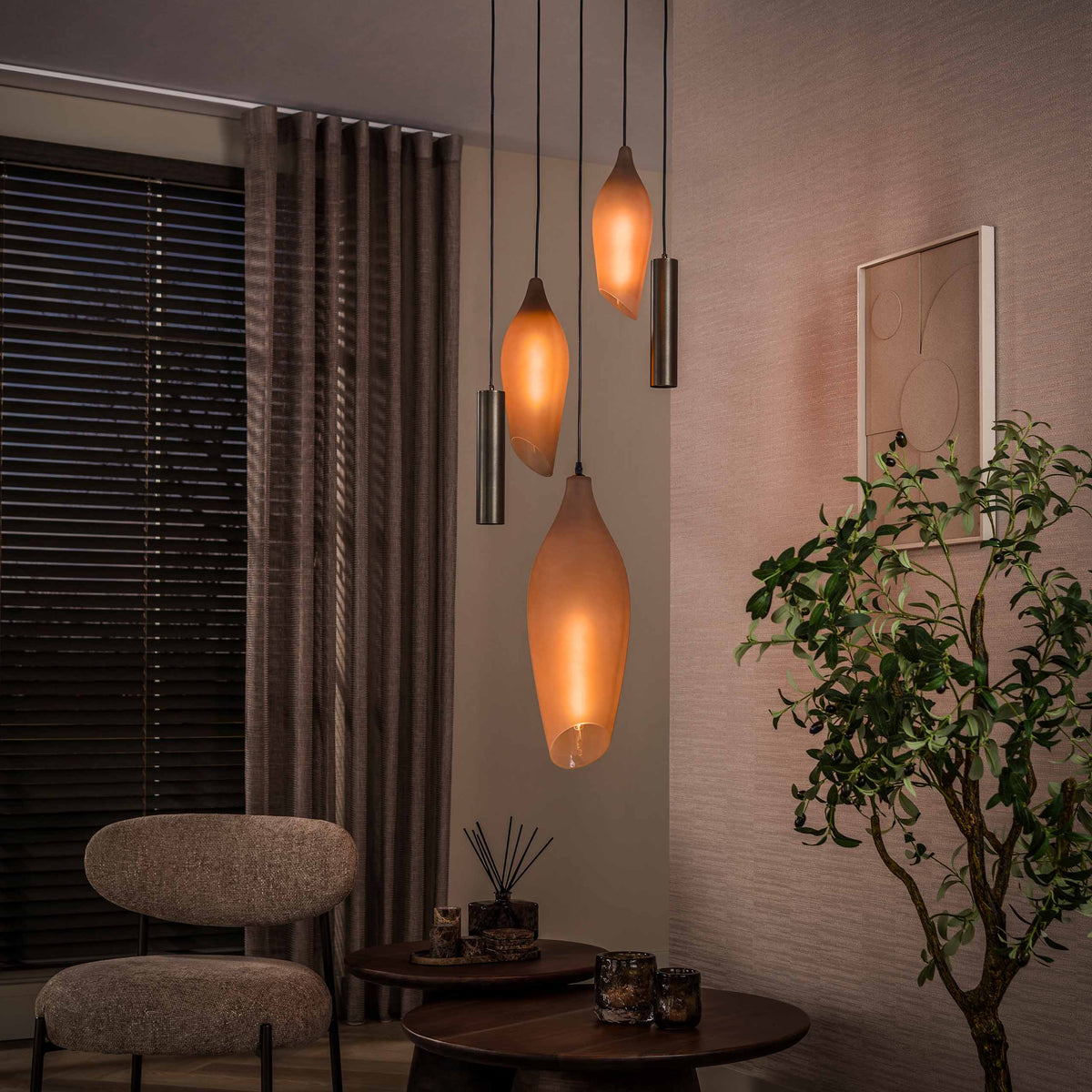 Hanglamp Alune van Meubelista in brons: sfeerfoto met alleen de glazen kappen verlicht.